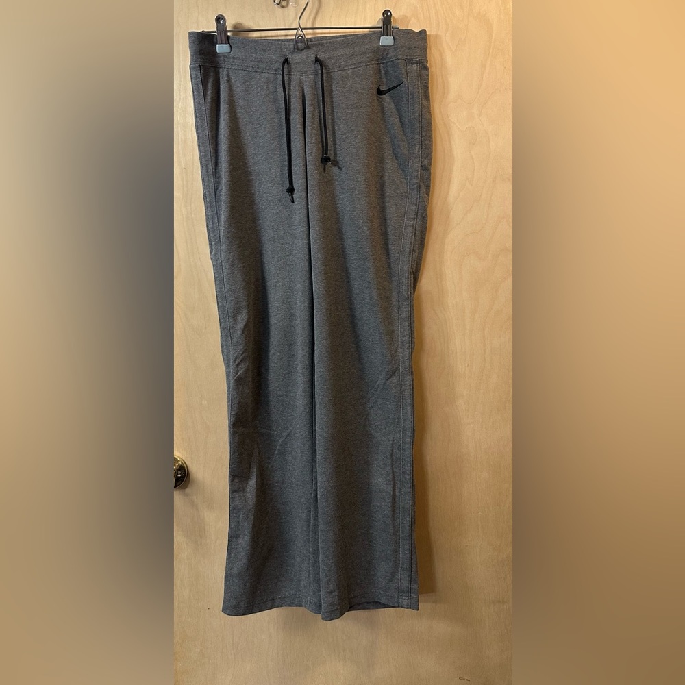 Nike gray drawstring pants size M, no pockets, gray stripes, flared legs, comfy
